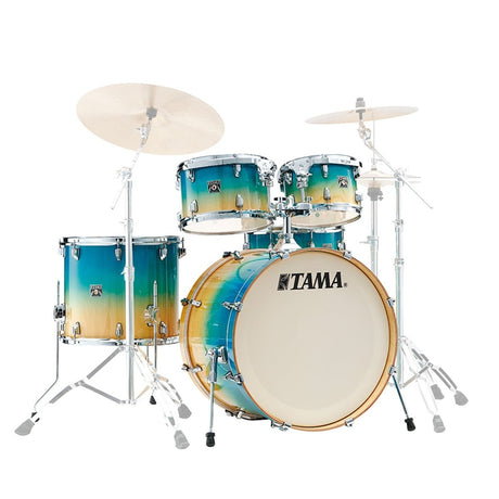 Tama drum set with gradient blue and orange finish on a white background